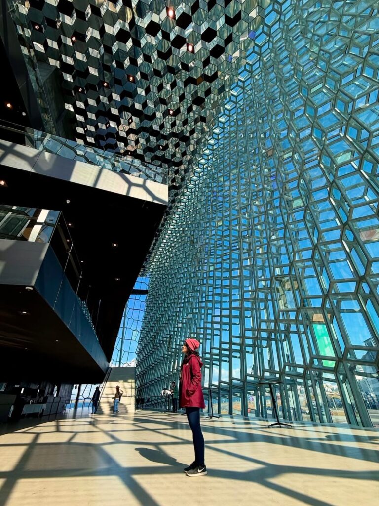 Image of a woman standing inside a glass building