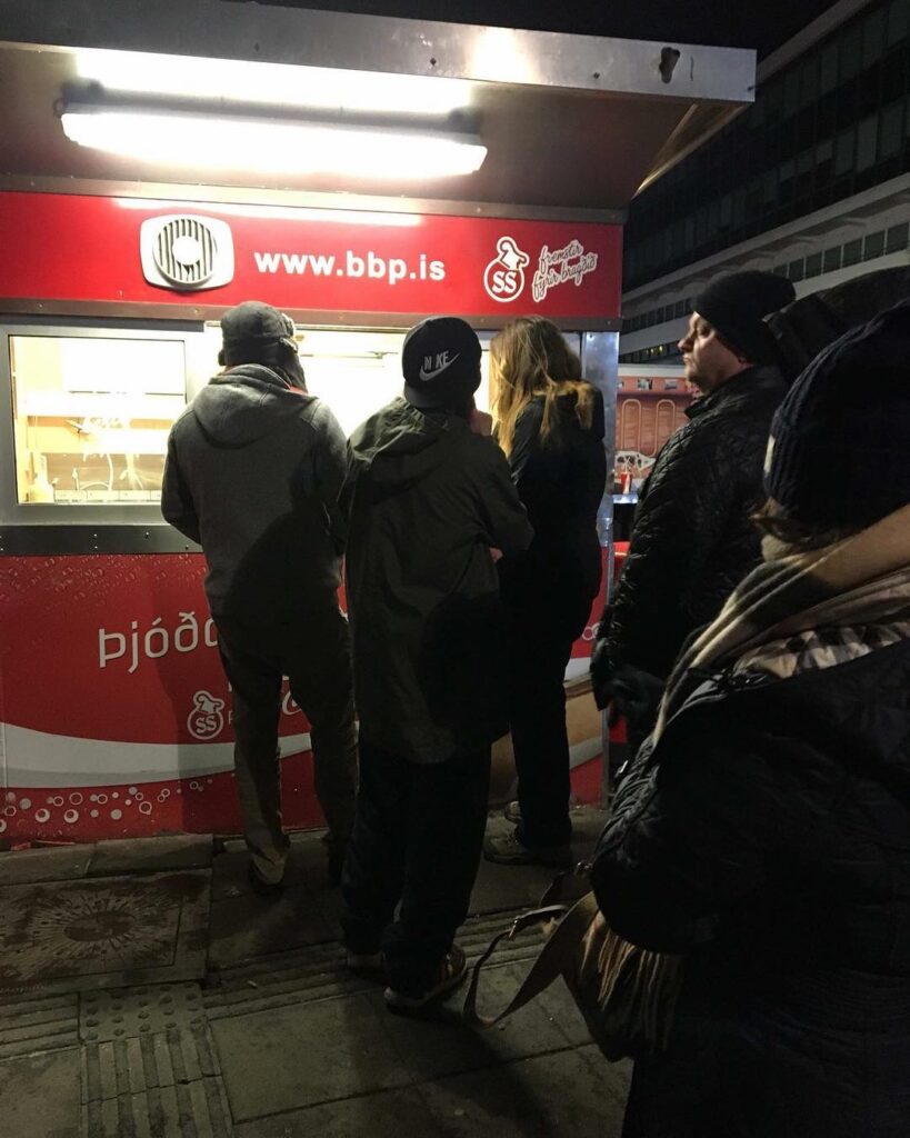 Image of people standing in front of a food stand