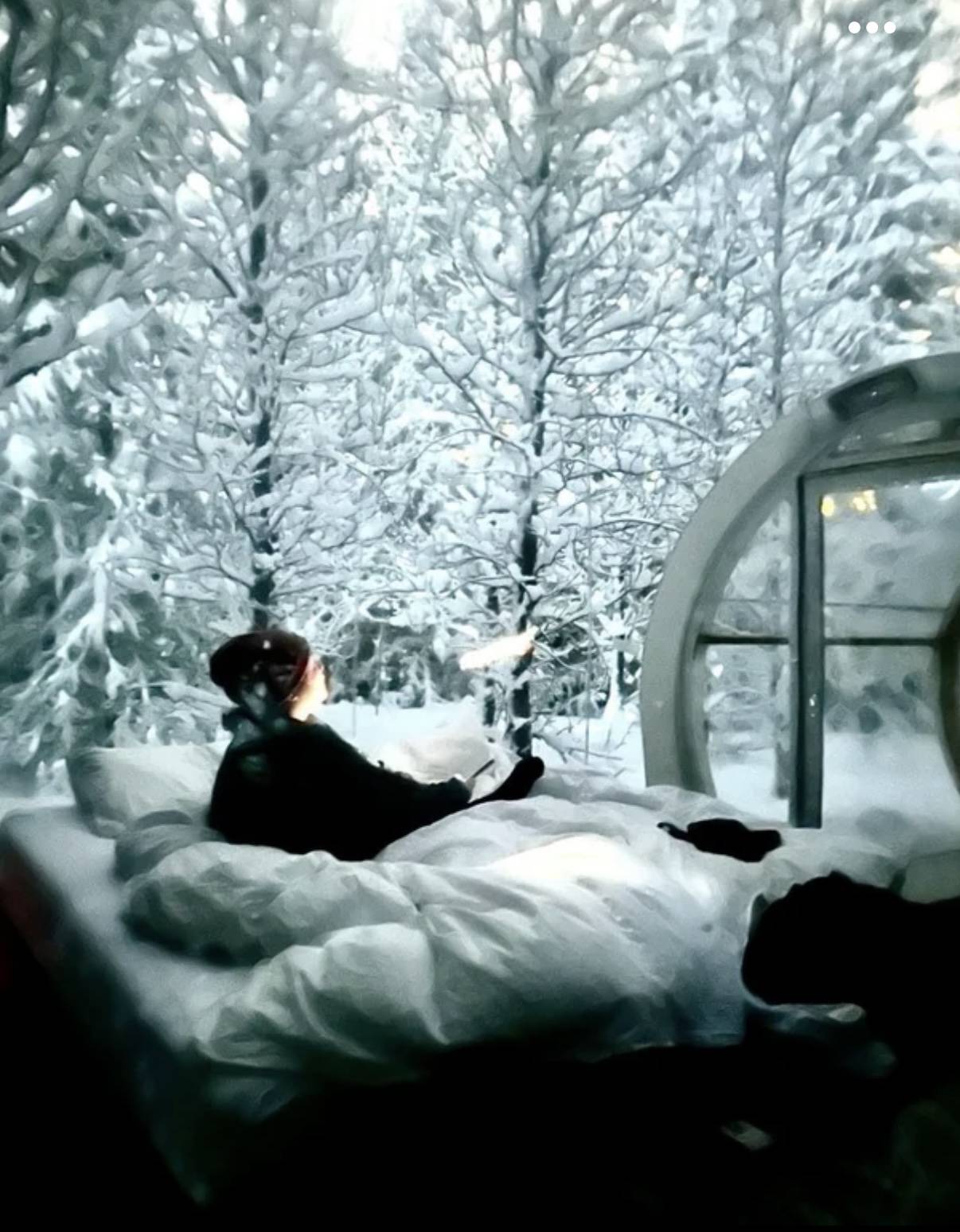 Woman in bed surrounded by snow